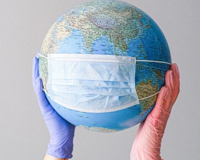 hands-with-latex-gloves-holding-a-globe-with-a-face-mask-4167544 (Demo)